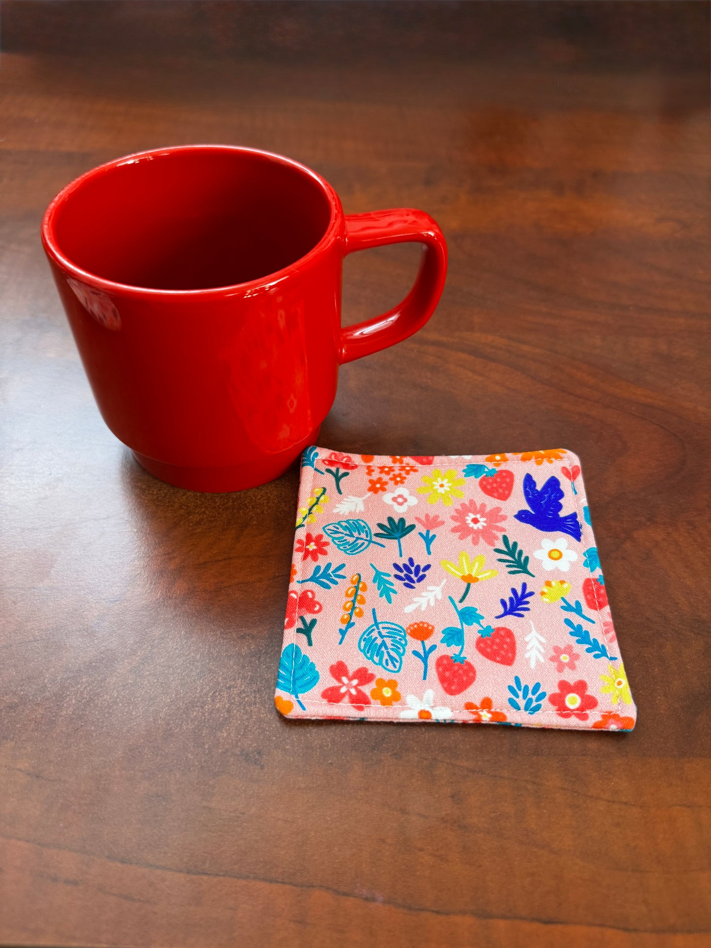 Elevate your space with this playful 100% cotton bird and bloom coaster. Featuring a vibrant and stylish floral and bird print, this coaster brings a touch of whimsical fun to your home. Crafted with an absorbent cotton batting layer inside, it's designed to soak up condensation and protect your furniture from unsightly water rings and spills. Perfect for coffee mugs, glasses, or teacups, this durable and machine-washable coaster is a delightful addition to your kitchen or living room. Elevate your home dec