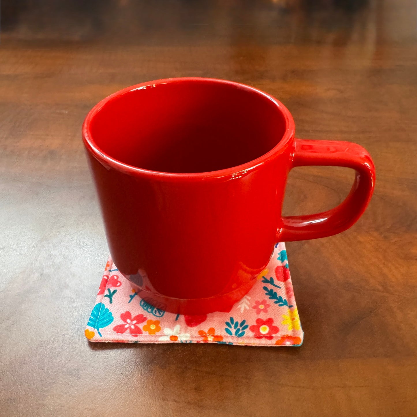 Elevate your space with this playful 100% cotton bird and bloom coaster. Featuring a vibrant and stylish floral and bird print, this coaster brings a touch of whimsical fun to your home. Crafted with an absorbent cotton batting layer inside, it's designed to soak up condensation and protect your furniture from unsightly water rings and spills. Perfect for coffee mugs, glasses, or teacups, this durable and machine-washable coaster is a delightful addition to your kitchen or living room. Elevate your home dec