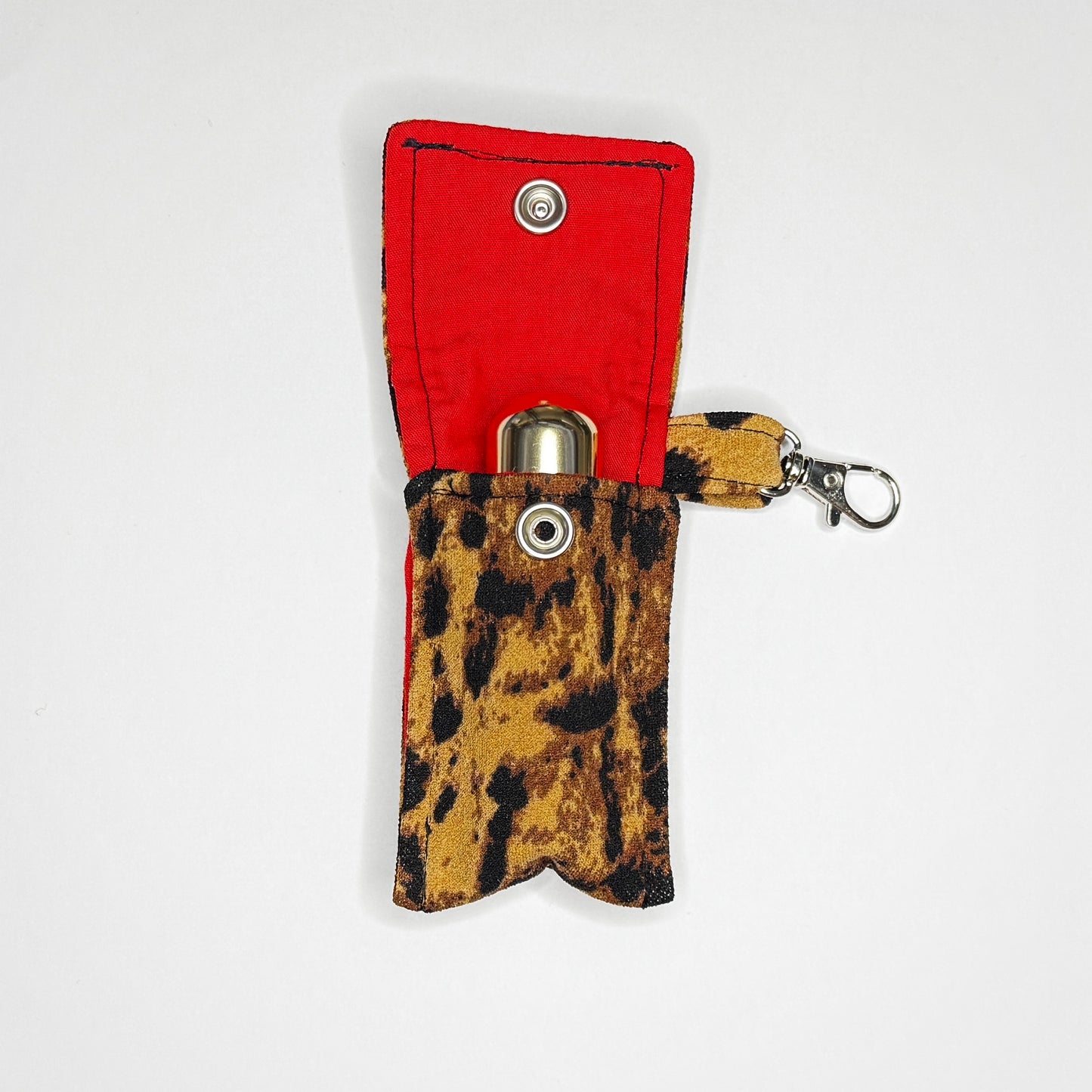 Keep your favorite lip color or balm secure and stylishly close at hand with this handmade fabric keychain pouch. Perfectly capturing a timeless rockabilly aesthetic and retro pin-up glamour, this compact accessory ensures you never lose your essentials at the bottom of your bag again.