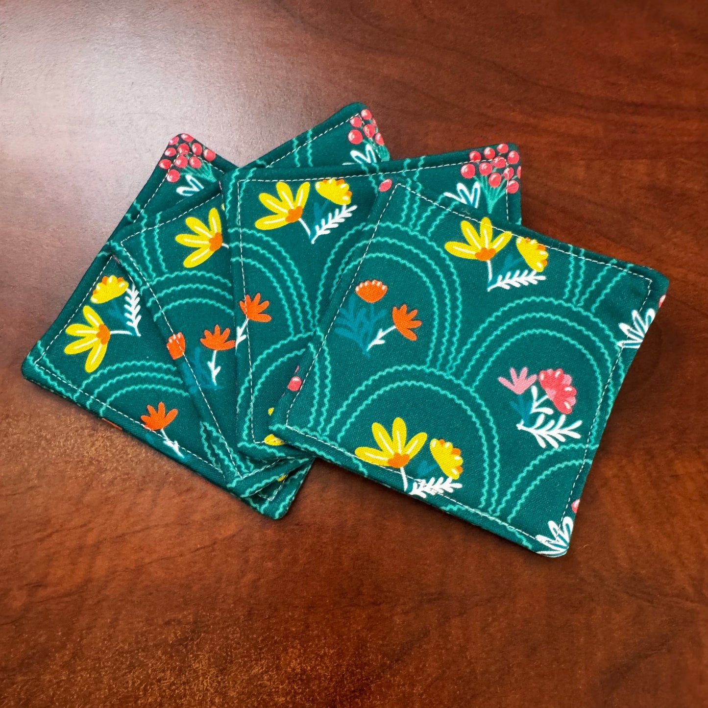 Elevate your space with this playful 100% cotton secret garden coaster. Featuring a vibrant and stylish floral print, this coaster brings a touch of floral and fun to your home. Crafted with an absorbent cotton batting layer inside, it's designed to soak up condensation and protect your furniture from unsightly water rings and spills. Perfect for coffee mugs, glasses, or teacups, this durable and machine-washable coaster is a delightful addition to your kitchen or living room.