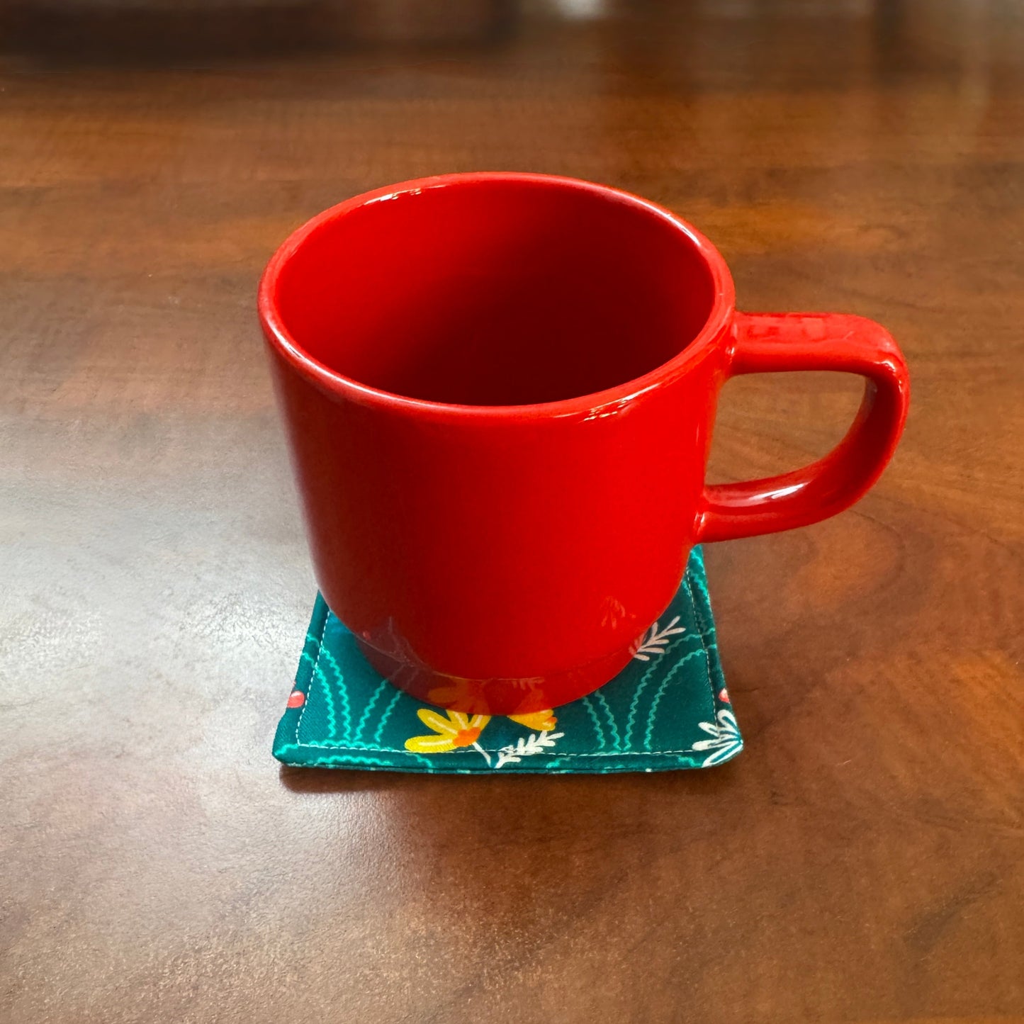 Elevate your space with this playful 100% cotton secret garden coaster. Featuring a vibrant and stylish floral print, this coaster brings a touch of floral and fun to your home. Crafted with an absorbent cotton batting layer inside, it's designed to soak up condensation and protect your furniture from unsightly water rings and spills. Perfect for coffee mugs, glasses, or teacups, this durable and machine-washable coaster is a delightful addition to your kitchen or living room.