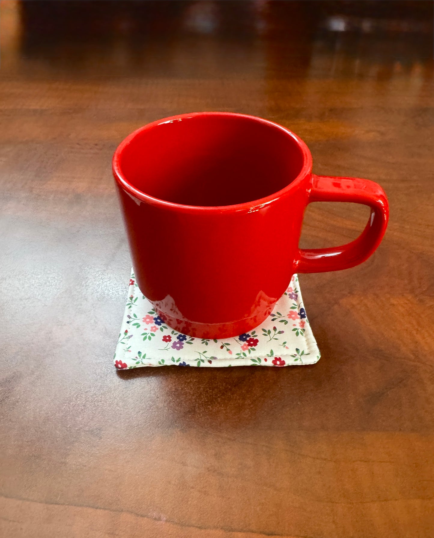 Elevate your space with this playful 100% cotton white floral coaster. Featuring a vibrant and stylish floral print, this coaster brings a touch of floral and fun to your home. Crafted with an absorbent cotton batting layer inside, it's designed to soak up condensation and protect your furniture from unsightly water rings and spills. Perfect for coffee mugs, glasses, or teacups, this durable and machine-washable coaster is a delightful addition to your kitchen or living room. Elevate your home decor with th