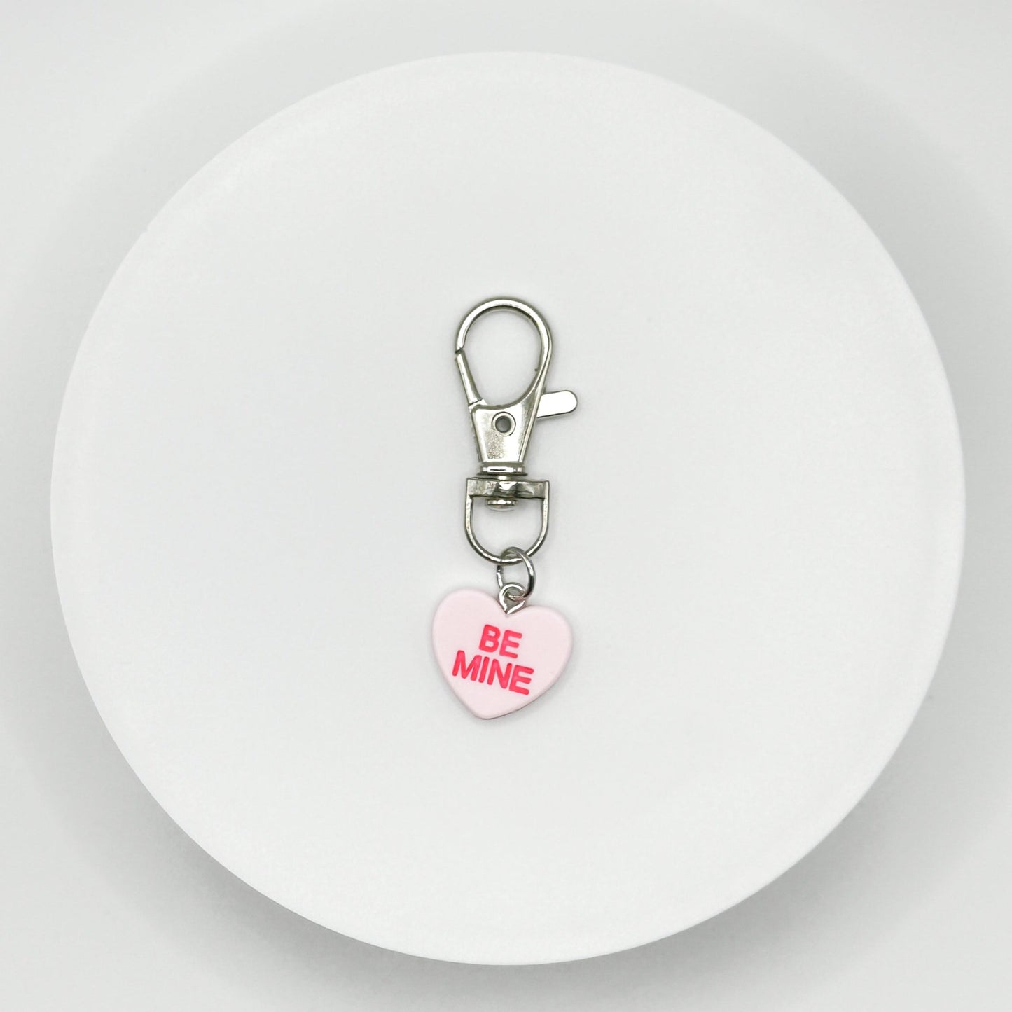 Add a touch of sweetness to your everyday! Our pink candy heart phone charm and keychain is the perfect accessory for Valentine’s Day and beyond. Cute, durable, and versatile, it’s the perfect gift for yourself or a loved one.