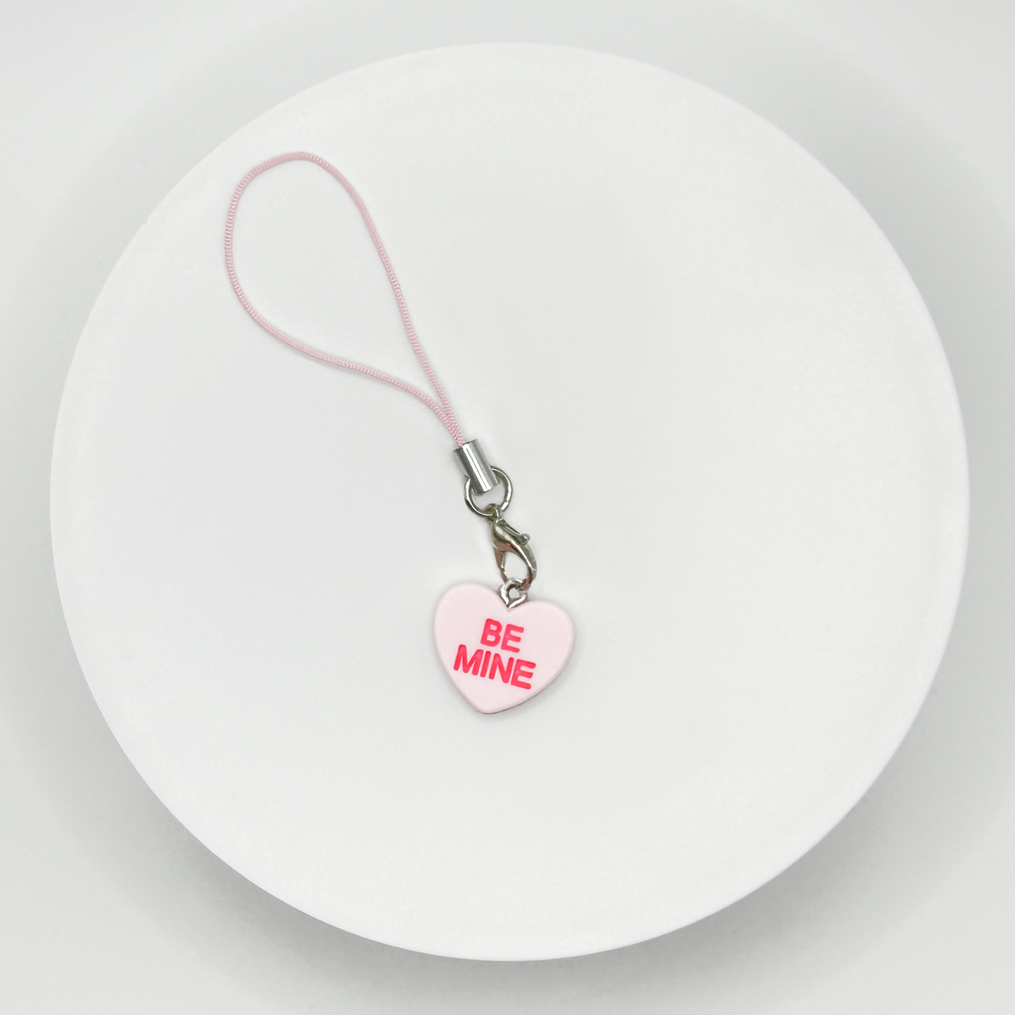 Add a touch of sweetness to your everyday! Our pink candy heart phone charm and keychain is the perfect accessory for Valentine’s Day and beyond. Cute, durable, and versatile, it’s the perfect gift for yourself or a loved one.