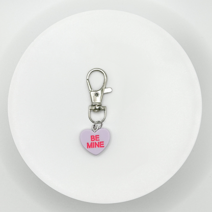 Add a touch of sweetness to your everyday! Our purple candy heart phone charm and keychain is the perfect accessory for Valentine’s Day and beyond. Cute, durable, and versatile, it’s the perfect gift for yourself or a loved one.