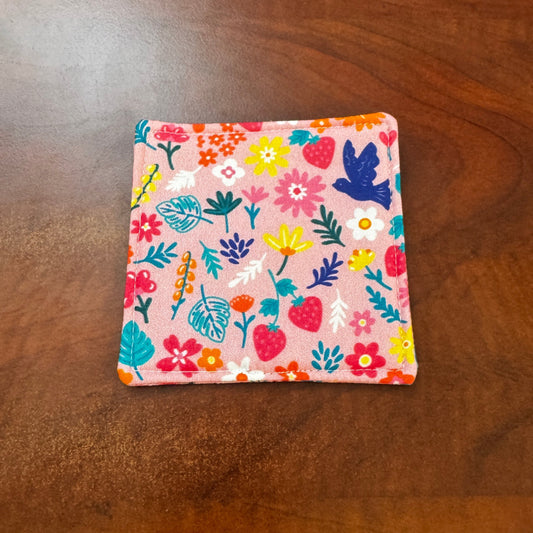 Elevate your space with this playful 100% cotton bird and bloom coaster. Featuring a vibrant and stylish floral and bird print, this coaster brings a touch of whimsical fun to your home. Crafted with an absorbent cotton batting layer inside, it's designed to soak up condensation and protect your furniture from unsightly water rings and spills. Perfect for coffee mugs, glasses, or teacups, this durable and machine-washable coaster is a delightful addition to your kitchen or living room. Elevate your home dec
