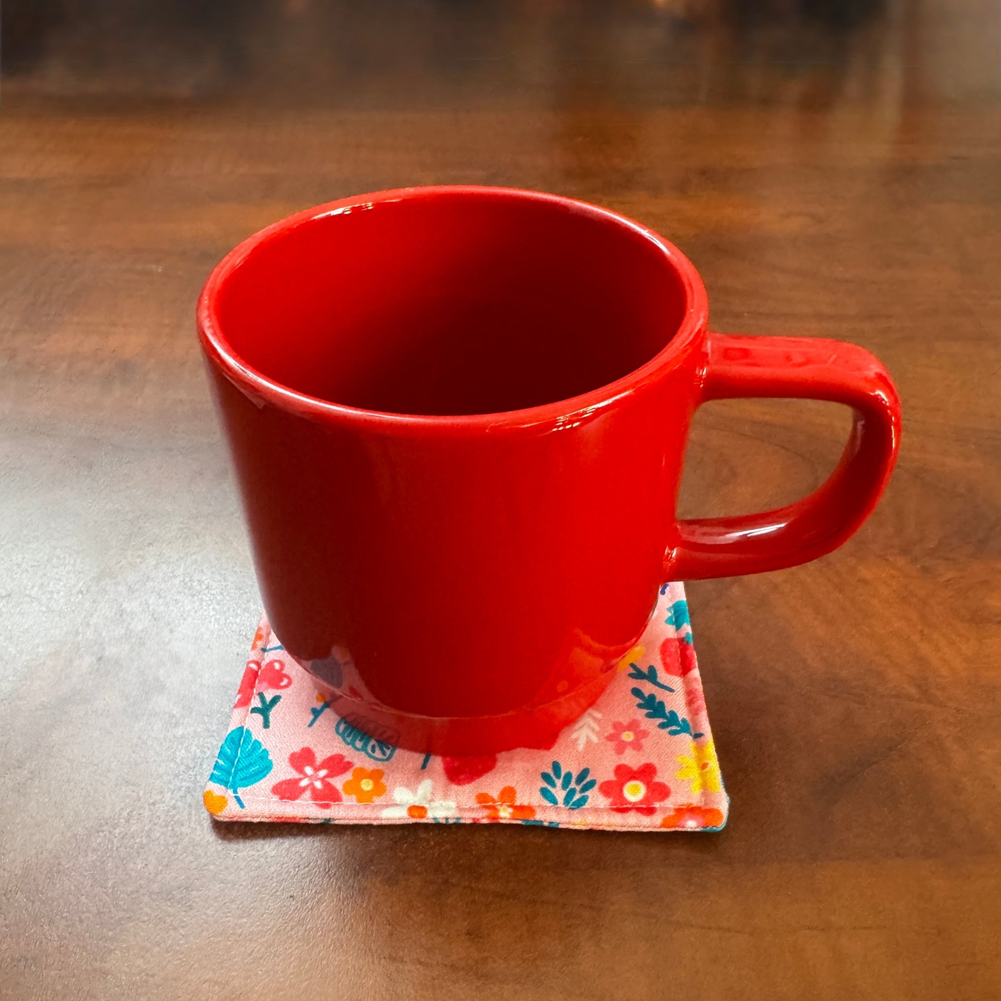 Elevate your space with this playful 100% cotton bird and bloom coaster. Featuring a vibrant and stylish floral and bird print, this coaster brings a touch of whimsical fun to your home. Crafted with an absorbent cotton batting layer inside, it's designed to soak up condensation and protect your furniture from unsightly water rings and spills. Perfect for coffee mugs, glasses, or teacups, this durable and machine-washable coaster is a delightful addition to your kitchen or living room. Elevate your home dec