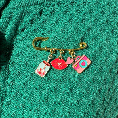 Elevate your Valentines Day or Galentines Day with this adorable gold iron pin brooch featuring coffee, lips, and a camera enamel charms. Perfect for adding a touch of love to any outfit.