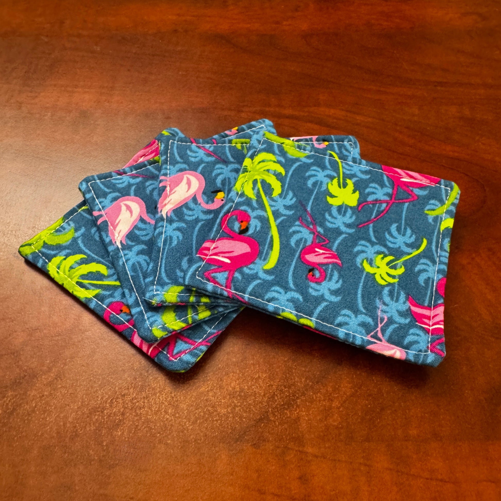 Elevate your space with this playful 100% cotton flamingo coaster. Featuring a vibrant and stylish flamingo print, this coaster brings a touch of tropical flair and fun to your home. Crafted with an absorbent cotton batting layer inside, it's designed to soak up condensation and protect your furniture from unsightly water rings and spills. Perfect for coffee mugs, glasses, or teacups, this durable and machine-washable coaster is a delightful addition to your kitchen or living room. Elevate your home decor w