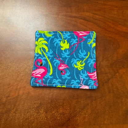 Elevate your space with this playful 100% cotton flamingo coaster. Featuring a vibrant and stylish flamingo print, this coaster brings a touch of tropical flair and fun to your home. Crafted with an absorbent cotton batting layer inside, it's designed to soak up condensation and protect your furniture from unsightly water rings and spills. Perfect for coffee mugs, glasses, or teacups, this durable and machine-washable coaster is a delightful addition to your kitchen or living room. Elevate your home decor w
