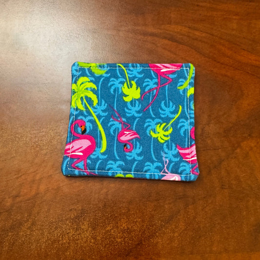 Elevate your space with this playful 100% cotton flamingo coaster. Featuring a vibrant and stylish flamingo print, this coaster brings a touch of tropical flair and fun to your home. Crafted with an absorbent cotton batting layer inside, it's designed to soak up condensation and protect your furniture from unsightly water rings and spills. Perfect for coffee mugs, glasses, or teacups, this durable and machine-washable coaster is a delightful addition to your kitchen or living room. Elevate your home decor w