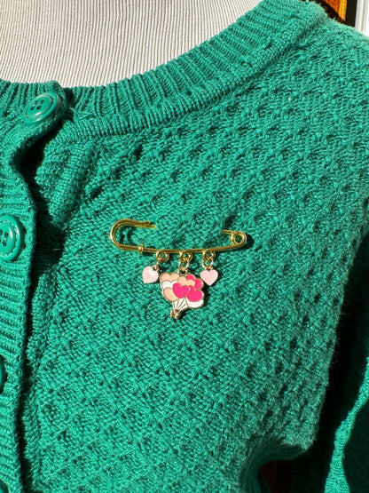 Elevate your Valentines Day or Galentines Day with this adorable gold iron pin brooch featuring heart balloons enamel charms. Perfect for adding a touch of love to any outfit.