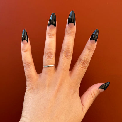 Get ready for "The Black Half Moon" and embrace dark glamour with these stunning handmade press-on nails, featuring a nude base and delicate, black half moon design