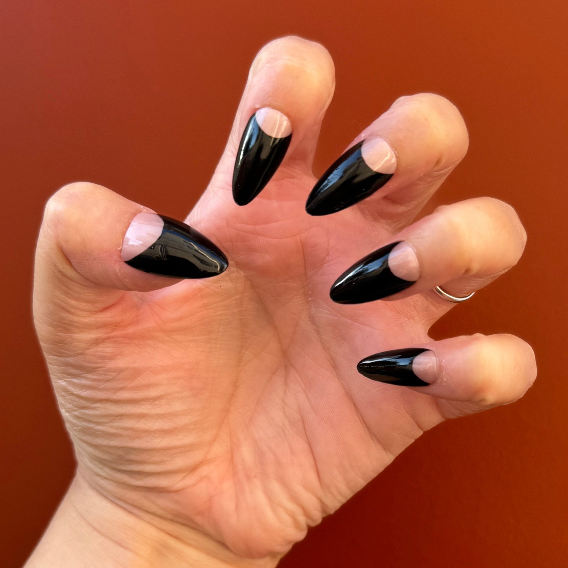 Get ready for "The Black Half Moon" and embrace dark glamour with these stunning handmade press-on nails, featuring a nude base and delicate, black half moon design