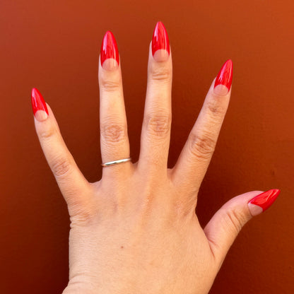 Get ready for "The Red Half Moon" and embrace dark glamour with these stunning handmade press-on nails, featuring a nude base and delicate, red half moon design.