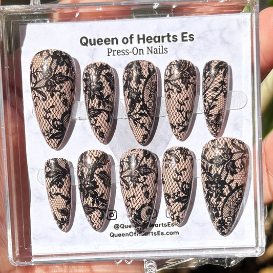 Get ready for "The Seductress" and embrace dark glamour with these stunning handmade press-on nails, featuring a rich nude base and delicate, black lace design.&nbsp;