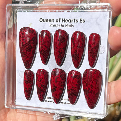 Get ready for "The Temptress" and embrace dark glamour with these stunning handmade press-on nails, featuring a rich dark base and delicate, red lace design.&nbsp;