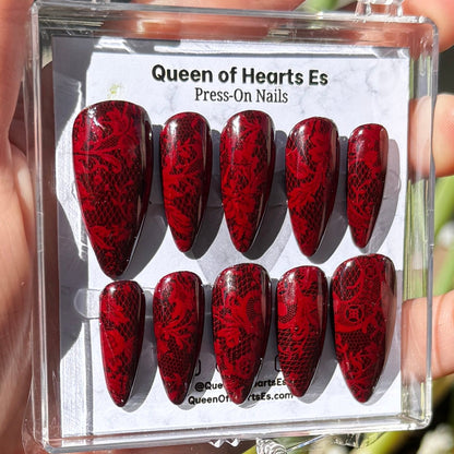 Get ready for "The Temptress" and embrace dark glamour with these stunning handmade press-on nails, featuring a rich dark base and delicate, red lace design.&nbsp;