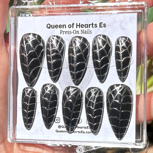 Get ready for "The Silver Weaver" and embrace dark glamour with these stunning handmade press-on nails, featuring a black base and delicate, silver/chrome spiderweb design.&nbsp;