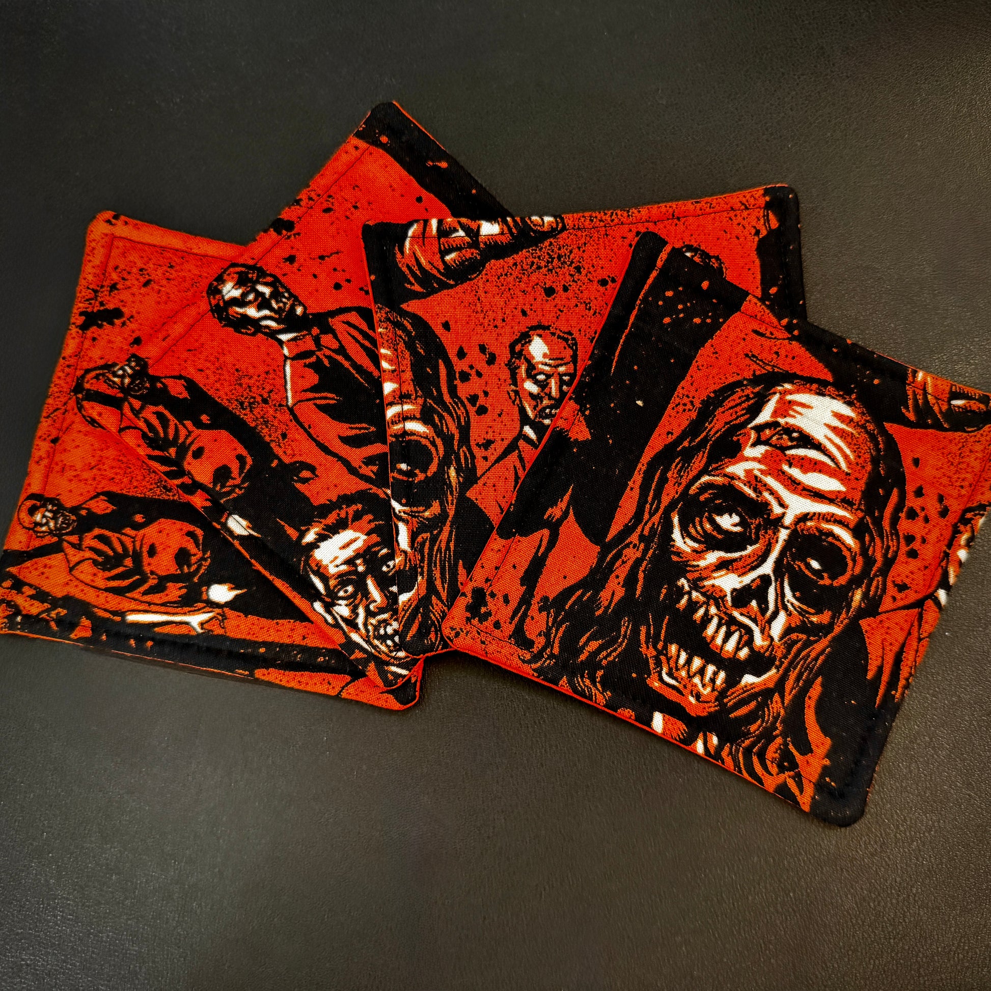 Summon the undead to your living space with this striking set of 4 handmade cotton coasters, inspired by classic B-movie horror and zombie comics. This set brings a bold, high-contrast alternative aesthetic to your surfaces.