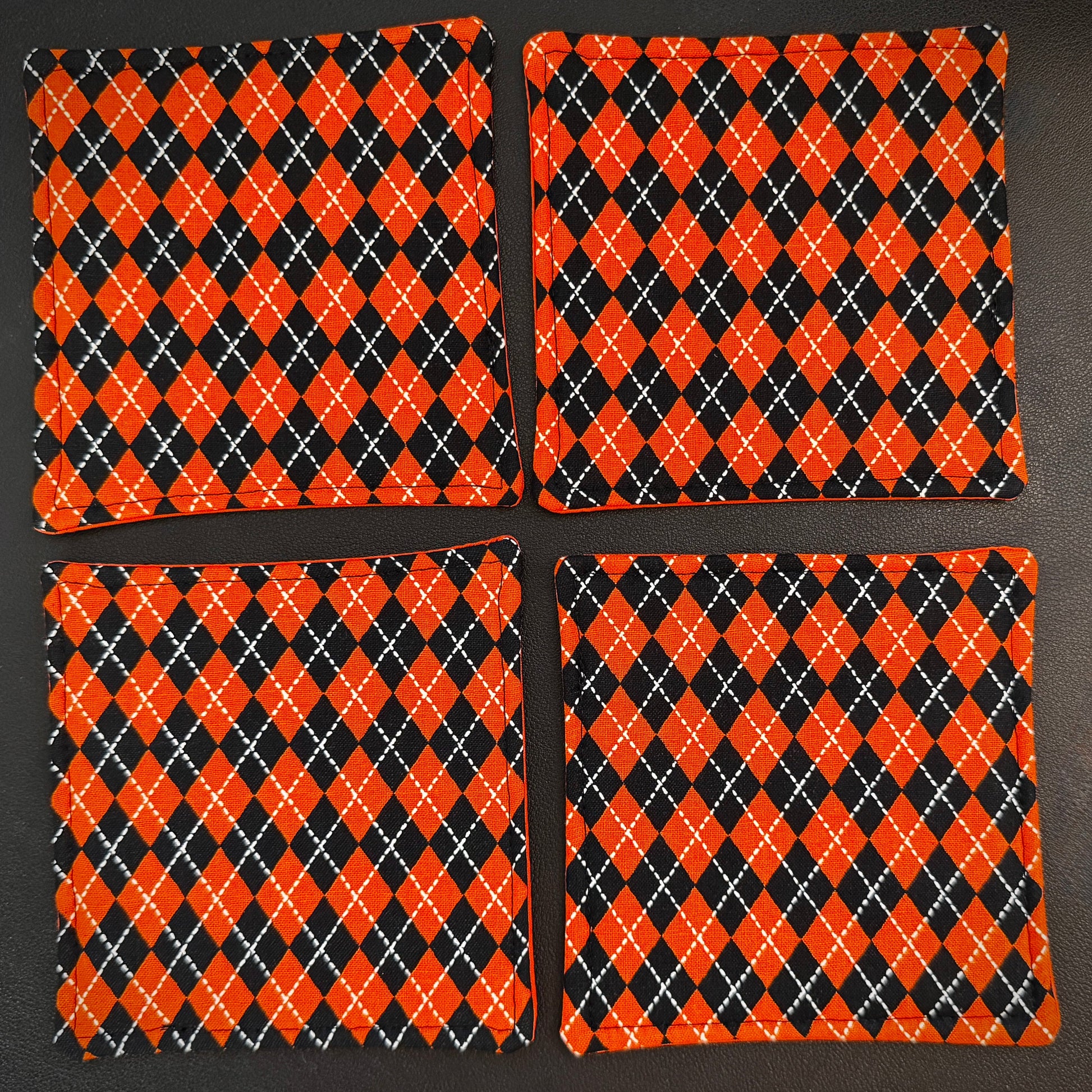 Bring a touch of retro mid-century charm and alternative flair to your tabletop with this set of 4 handmade cotton coasters. Featuring a striking, high-contrast geometric pattern, these coasters perfectly blend vintage pin-up glamour, rockabilly style, and a subtle nod to classic spooky aesthetics.