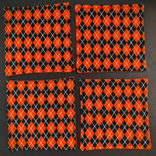 Bring a touch of retro mid-century charm and alternative flair to your tabletop with this set of 4 handmade cotton coasters. Featuring a striking, high-contrast geometric pattern, these coasters perfectly blend vintage pin-up glamour, rockabilly style, and a subtle nod to classic spooky aesthetics.