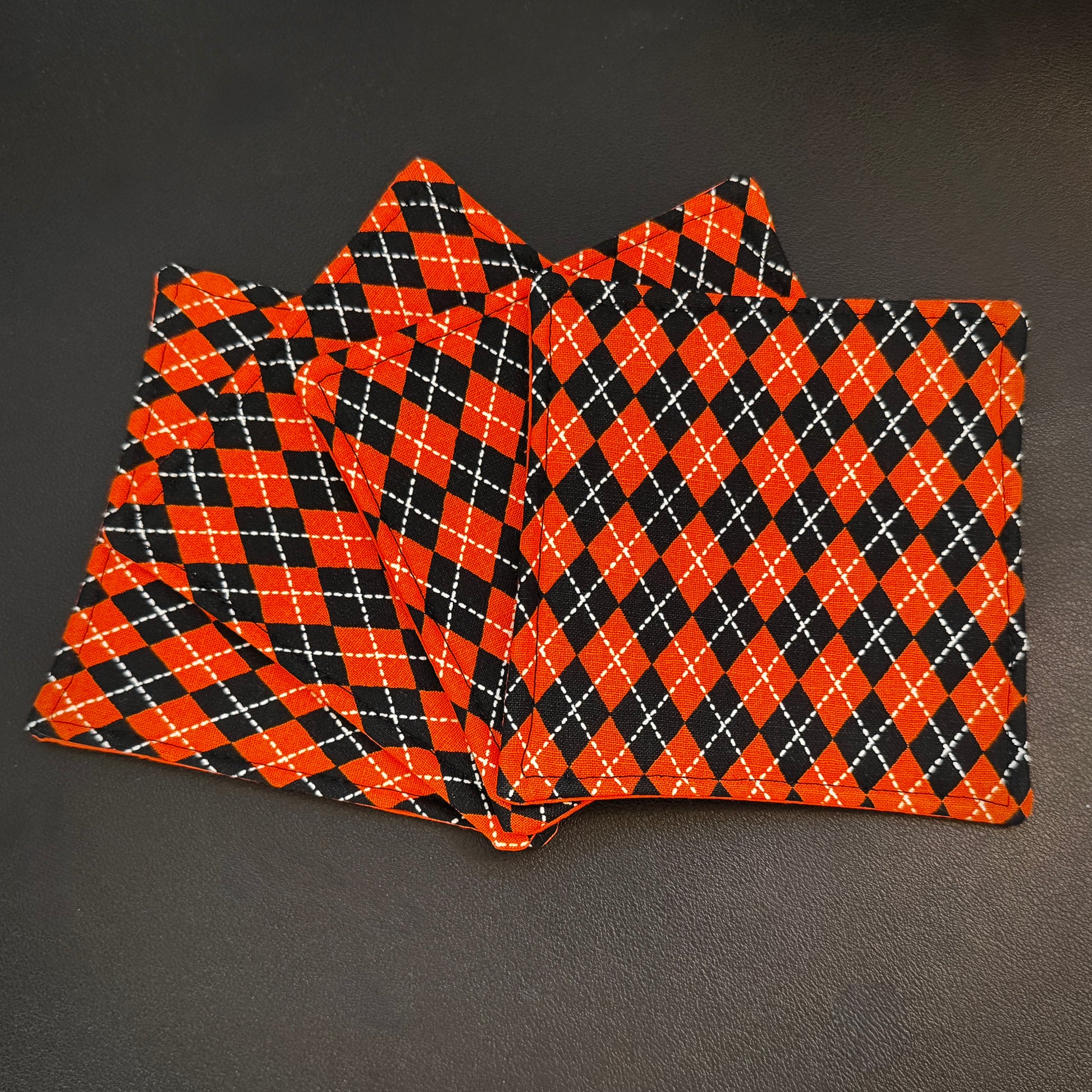 Bring a touch of retro mid-century charm and alternative flair to your tabletop with this set of 4 handmade cotton coasters. Featuring a striking, high-contrast geometric pattern, these coasters perfectly blend vintage pin-up glamour, rockabilly style, and a subtle nod to classic spooky aesthetics.