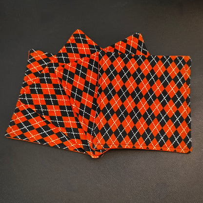 Bring a touch of retro mid-century charm and alternative flair to your tabletop with this set of 4 handmade cotton coasters. Featuring a striking, high-contrast geometric pattern, these coasters perfectly blend vintage pin-up glamour, rockabilly style, and a subtle nod to classic spooky aesthetics.