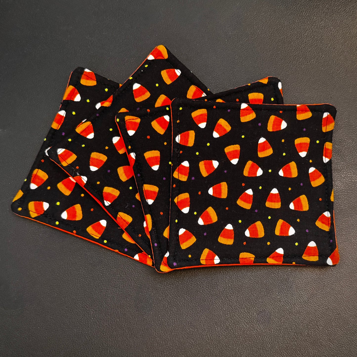 Celebrate the sweeter side of the spooky season all year round with this matching set of 4 handmade cotton coasters. Perfectly capturing a playful, retro autumn kitsch aesthetic, these drink mats bring a vibrant, nostalgic pop of color to any alternative home decor collection.