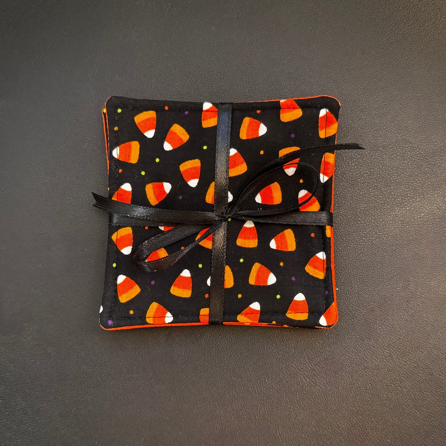Celebrate the sweeter side of the spooky season all year round with this matching set of 4 handmade cotton coasters. Perfectly capturing a playful, retro autumn kitsch aesthetic, these drink mats bring a vibrant, nostalgic pop of color to any alternative home decor collection.