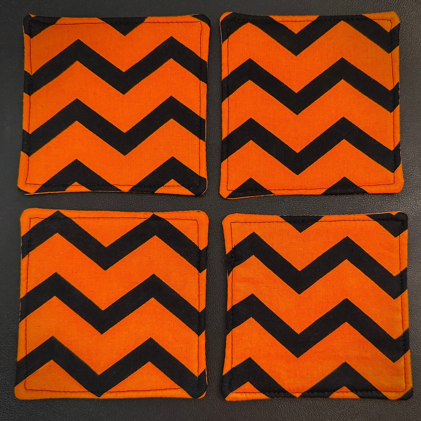 Infuse your home with a bold pop of graphic design and alternative flair with this set of 4 handmade cotton coasters. Showcasing a striking, wide zigzag pattern, these drink mats bring together a mid-century retro vibe with an unmistakably edgy, dark aesthetic.