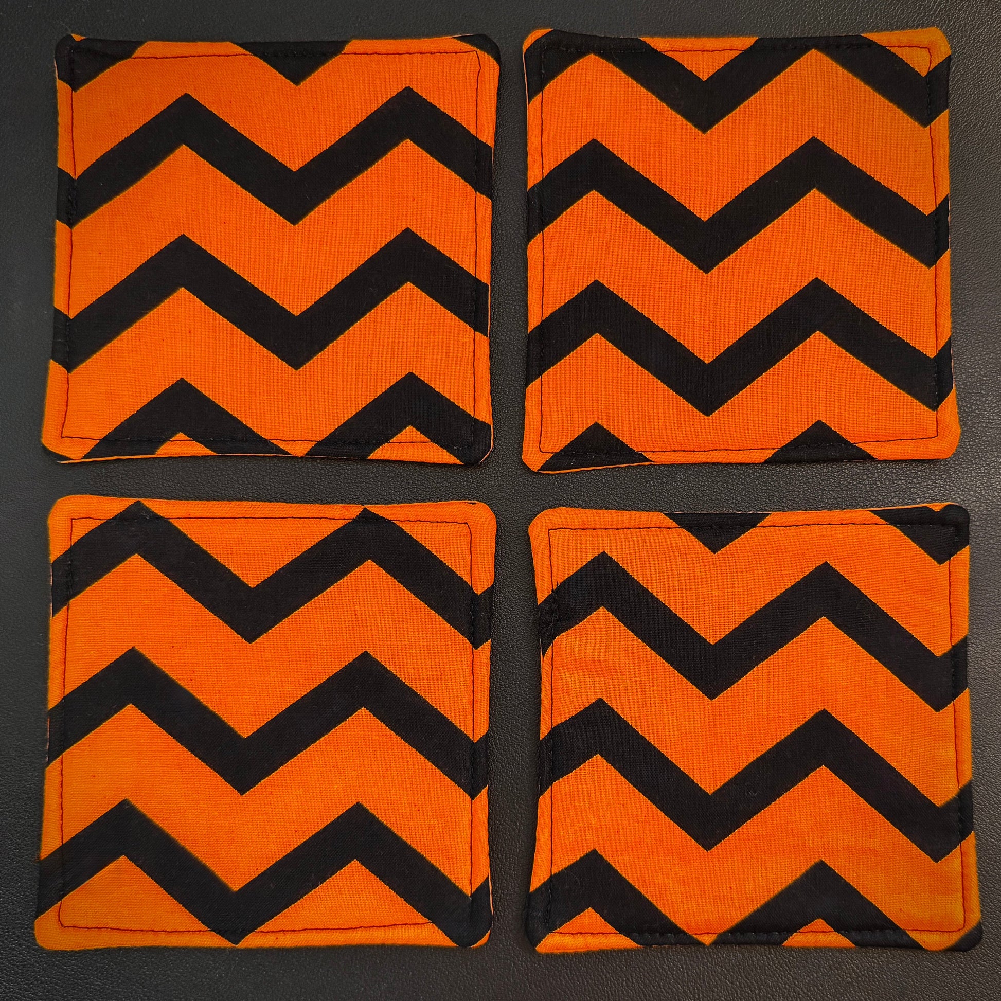 Infuse your home with a bold pop of graphic design and alternative flair with this set of 4 handmade cotton coasters. Showcasing a striking, wide zigzag pattern, these drink mats bring together a mid-century retro vibe with an unmistakably edgy, dark aesthetic.