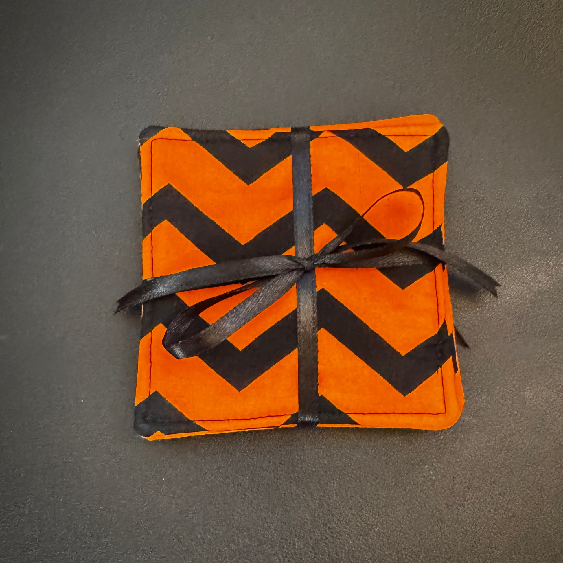 Infuse your home with a bold pop of graphic design and alternative flair with this set of 4 handmade cotton coasters. Showcasing a striking, wide zigzag pattern, these drink mats bring together a mid-century retro vibe with an unmistakably edgy, dark aesthetic.