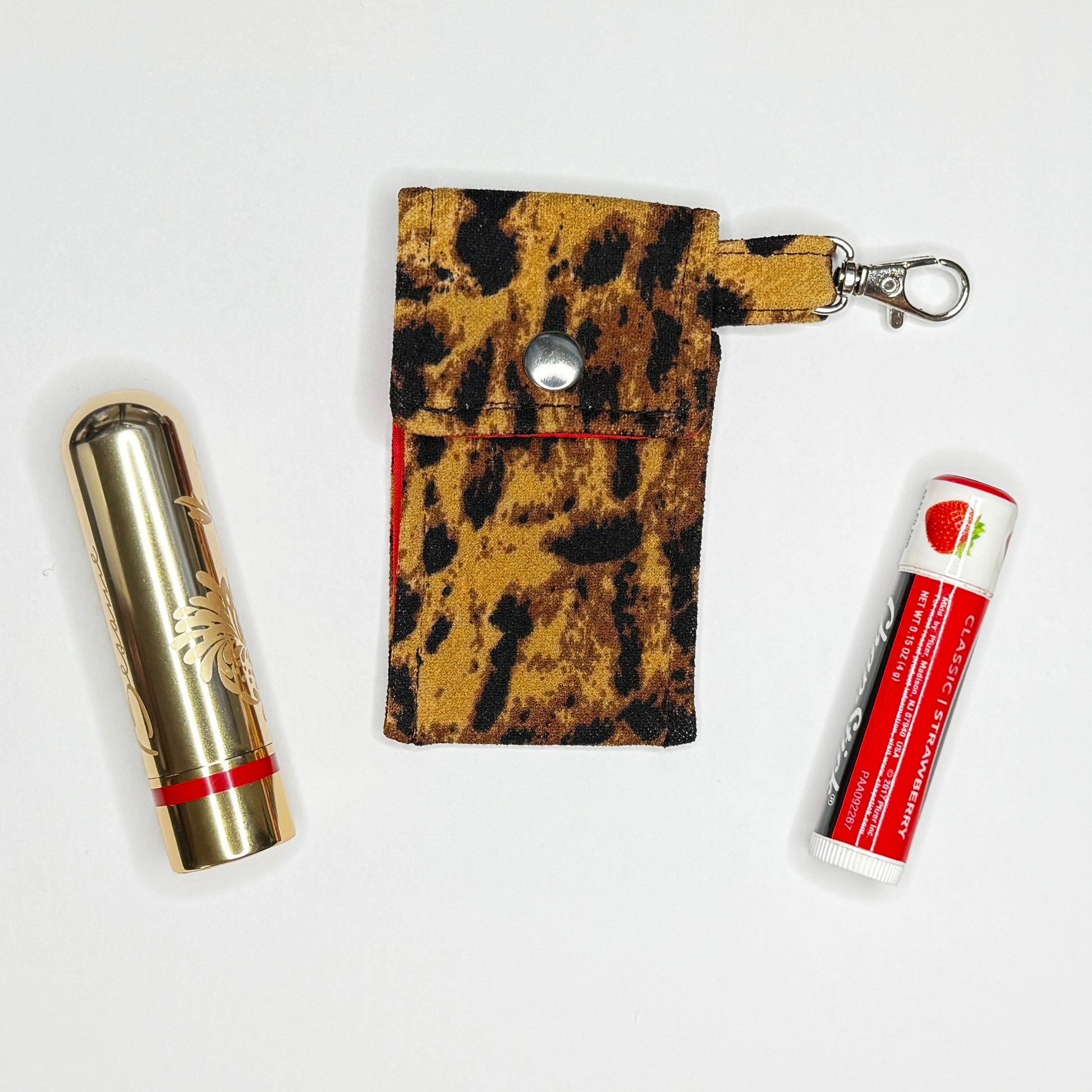 Keep your favorite lip color or balm secure and stylishly close at hand with this handmade fabric keychain pouch. Perfectly capturing a timeless rockabilly aesthetic and retro pin-up glamour, this compact accessory ensures you never lose your essentials at the bottom of your bag again.