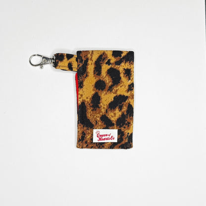 Keep your favorite lip color or balm secure and stylishly close at hand with this handmade fabric keychain pouch. Perfectly capturing a timeless rockabilly aesthetic and retro pin-up glamour, this compact accessory ensures you never lose your essentials at the bottom of your bag again.