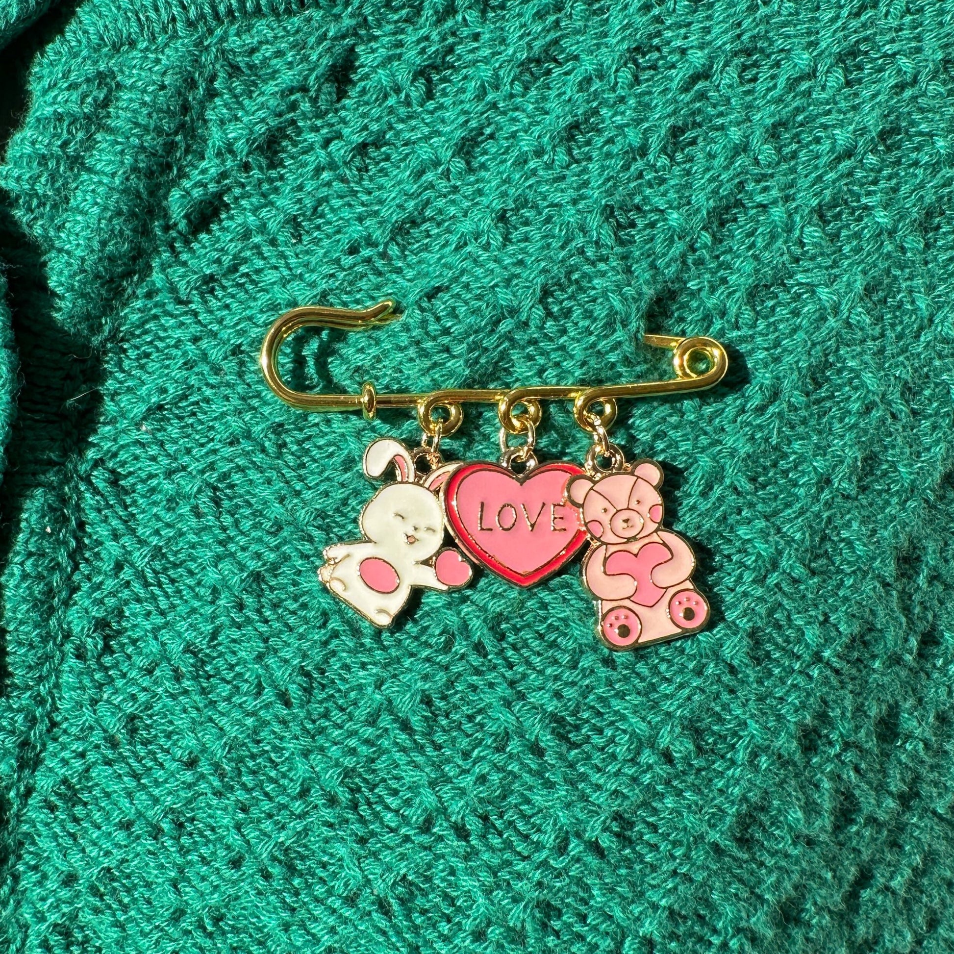 Elevate your Valentines Day or Galentines Day with this adorable gold iron pin brooch featuring a cute stuffed bunny and teddy bear enamel charms. Perfect for adding a touch of love to any outfit.