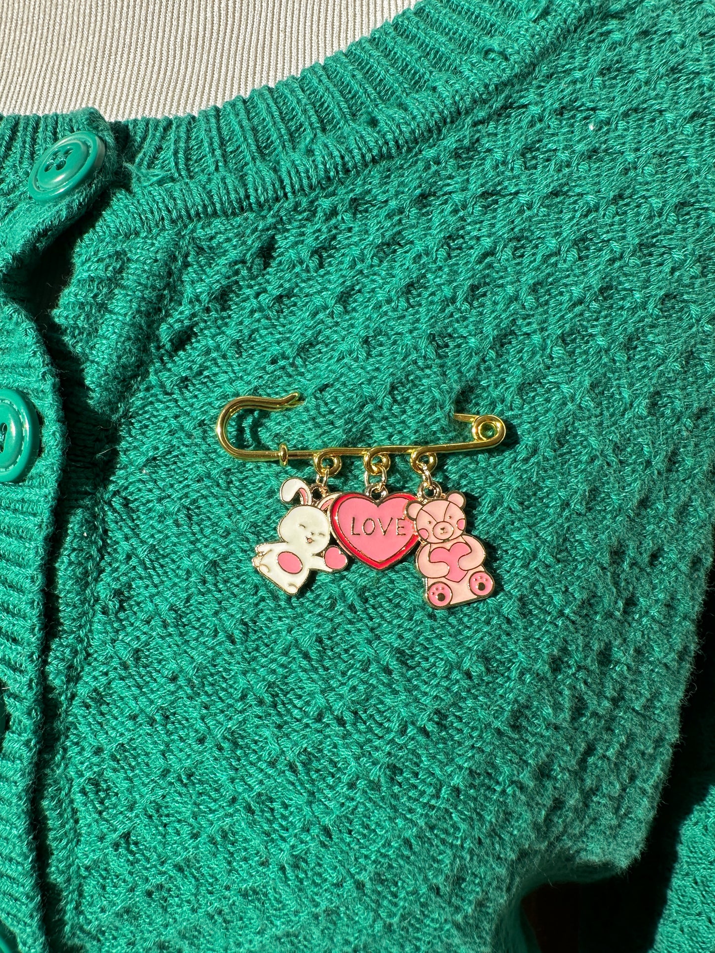 Elevate your Valentines Day or Galentines Day with this adorable gold iron pin brooch featuring a cute stuffed bunny and teddy bear enamel charms. Perfect for adding a touch of love to any outfit.