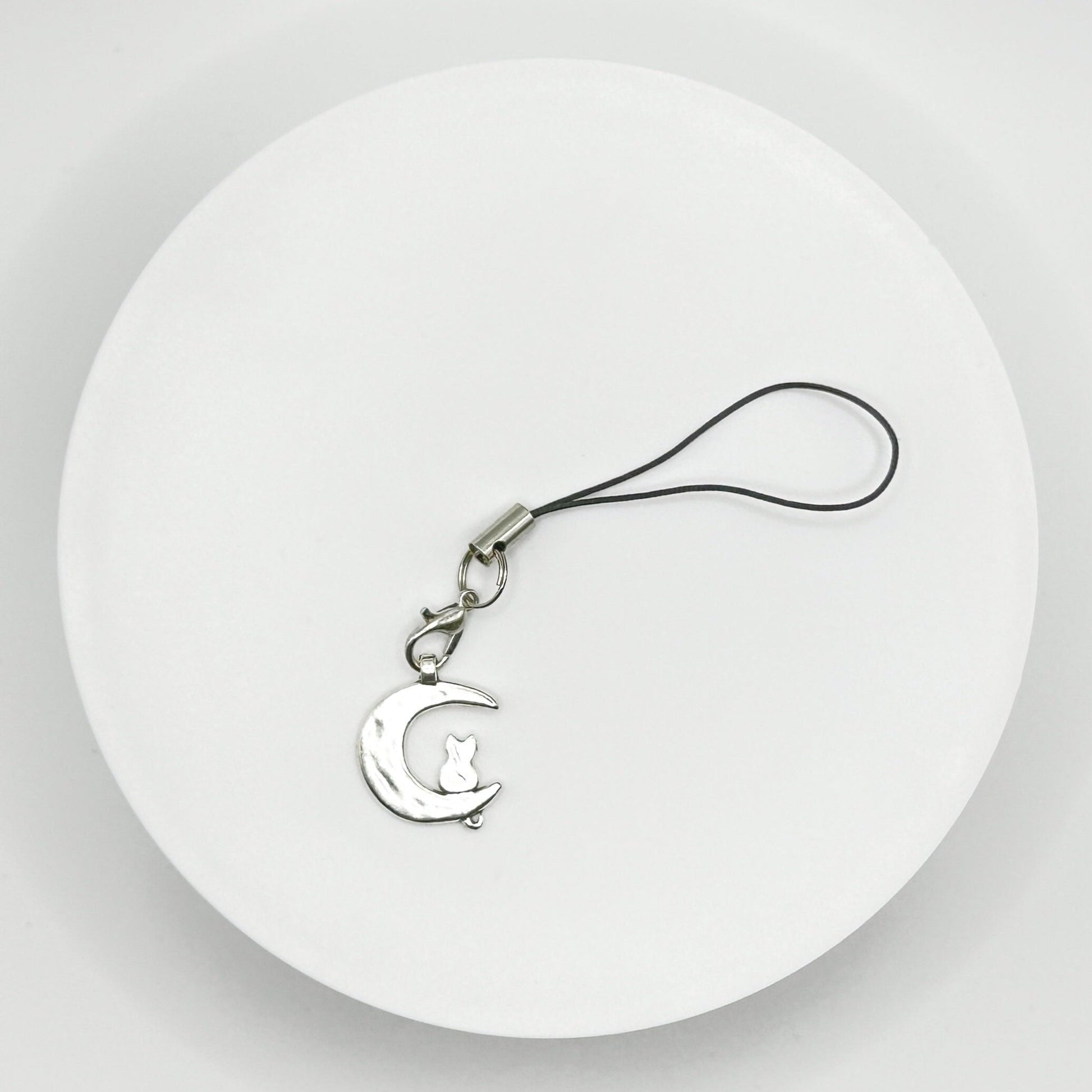 Add a touch of cosmic cuteness to your everyday with our adorable cat on the moon charm. Perfect for cat lovers and space enthusiasts. Durable, versatile, and makes a great gift. Shop now!