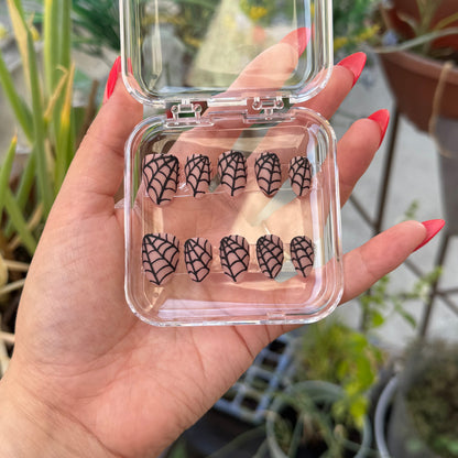 Get ready for "Nude Web" with these stunning, spiderweb design press-on nails. Featuring a nude base and black web with a matte finish. Each set is a miniature work of art, meticulously designed and hand-painted, adding a unique flair to any occasion. No time for salon appointments? Say hello to instant glamour that’s ready whenever you are. Our durable, high-quality press-ons offer a flawless, comfortable fit and are designed to last.