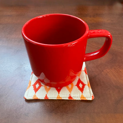Elevate your space with this playful 100% cotton retro diamond coaster. Featuring a vibrant and stylish retro diamond print, this coaster brings a touch of retro flair and fun to your home. Crafted with an absorbent cotton batting layer inside, it's designed to soak up condensation and protect your furniture from unsightly water rings and spills. Perfect for coffee mugs, glasses, or teacups, this durable and machine-washable coaster is a delightful addition to your kitchen or living room. Elevate your home 