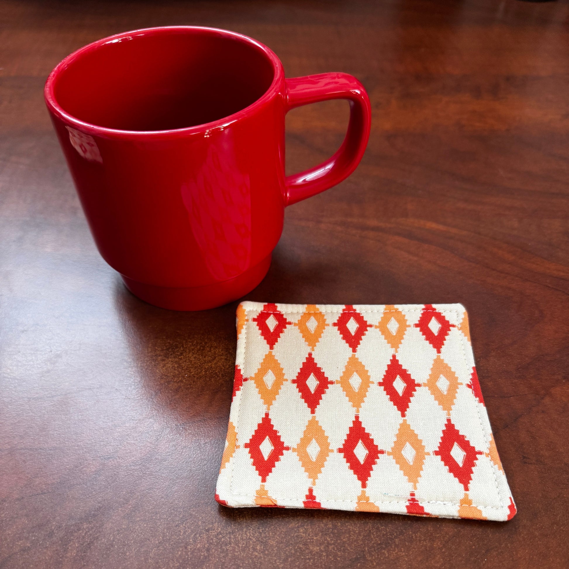 Elevate your space with this playful 100% cotton retro diamond coaster. Featuring a vibrant and stylish retro diamond print, this coaster brings a touch of retro flair and fun to your home. Crafted with an absorbent cotton batting layer inside, it's designed to soak up condensation and protect your furniture from unsightly water rings and spills. Perfect for coffee mugs, glasses, or teacups, this durable and machine-washable coaster is a delightful addition to your kitchen or living room. Elevate your home 
