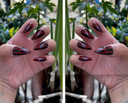 Get ready for "The Grid" and step into the future with custom, hand-painted press-on nails inspired by high-tech cyber circuitry and sci-fi aesthetic. Featuring slick, high-gloss black bases layered with ultra-crisp circuit linework, "The Grid" charges up under UV or sunlight to emit a vivid, electric glow when the lights go down. Available in both blue and red glow finishes!