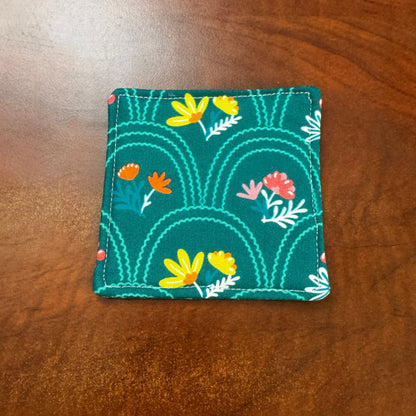 Elevate your space with this playful 100% cotton secret garden coaster. Featuring a vibrant and stylish floral print, this coaster brings a touch of floral and fun to your home. Crafted with an absorbent cotton batting layer inside, it's designed to soak up condensation and protect your furniture from unsightly water rings and spills. Perfect for coffee mugs, glasses, or teacups, this durable and machine-washable coaster is a delightful addition to your kitchen or living room. 