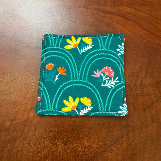 Elevate your space with this playful 100% cotton secret garden coaster. Featuring a vibrant and stylish floral print, this coaster brings a touch of floral and fun to your home. Crafted with an absorbent cotton batting layer inside, it's designed to soak up condensation and protect your furniture from unsightly water rings and spills. Perfect for coffee mugs, glasses, or teacups, this durable and machine-washable coaster is a delightful addition to your kitchen or living room. 