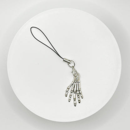 Grasp your style with our spooky skeleton hand charm! This unique, durable, and versatile accessory is perfect for horror fans and dark style lovers. Attach it to your bag, purse, or backpack for a touch of the macabre.