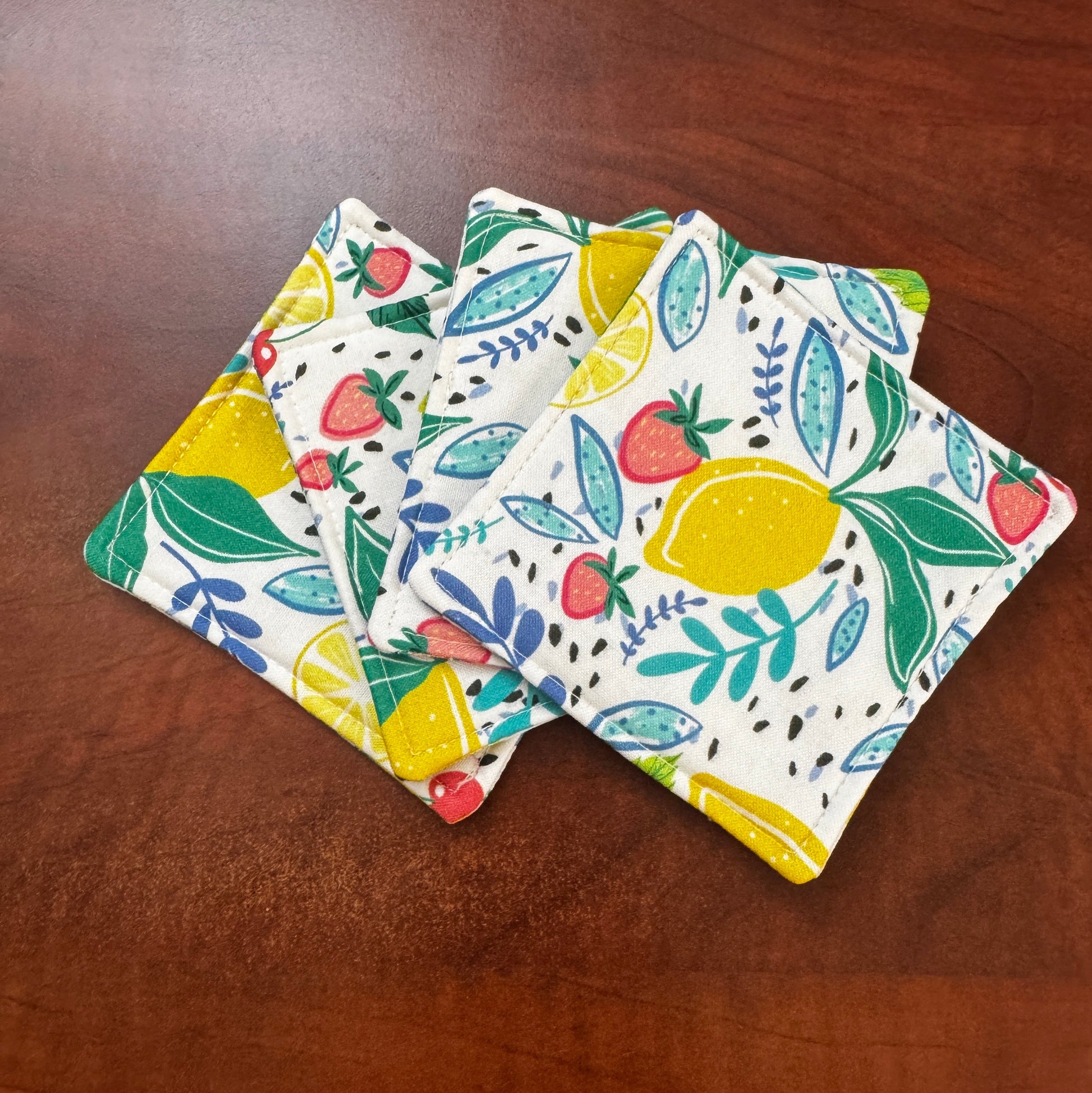 Keep your surfaces safe and stylish with our 100% cotton strawberry and lemon coaster. This charming coaster features a vibrant strawberry and lemon print that adds a touch of fresh, fruity fun to any room. Crafted with an absorbent cotton batting layer inside, it's designed to soak up condensation and protect your furniture from unsightly water rings and spills. Perfect for coffee mugs, glasses, or teacups, this durable and machine-washable coaster is a delightful addition to your kitchen or living room. E