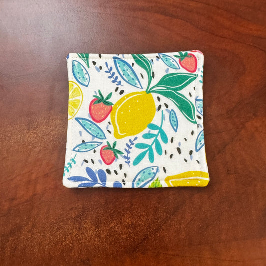 Keep your surfaces safe and stylish with our 100% cotton strawberry and lemon coaster. This charming coaster features a vibrant strawberry and lemon print that adds a touch of fresh, fruity fun to any room. Crafted with an absorbent cotton batting layer inside, it's designed to soak up condensation and protect your furniture from unsightly water rings and spills. Perfect for coffee mugs, glasses, or teacups, this durable and machine-washable coaster is a delightful addition to your kitchen or living room. E