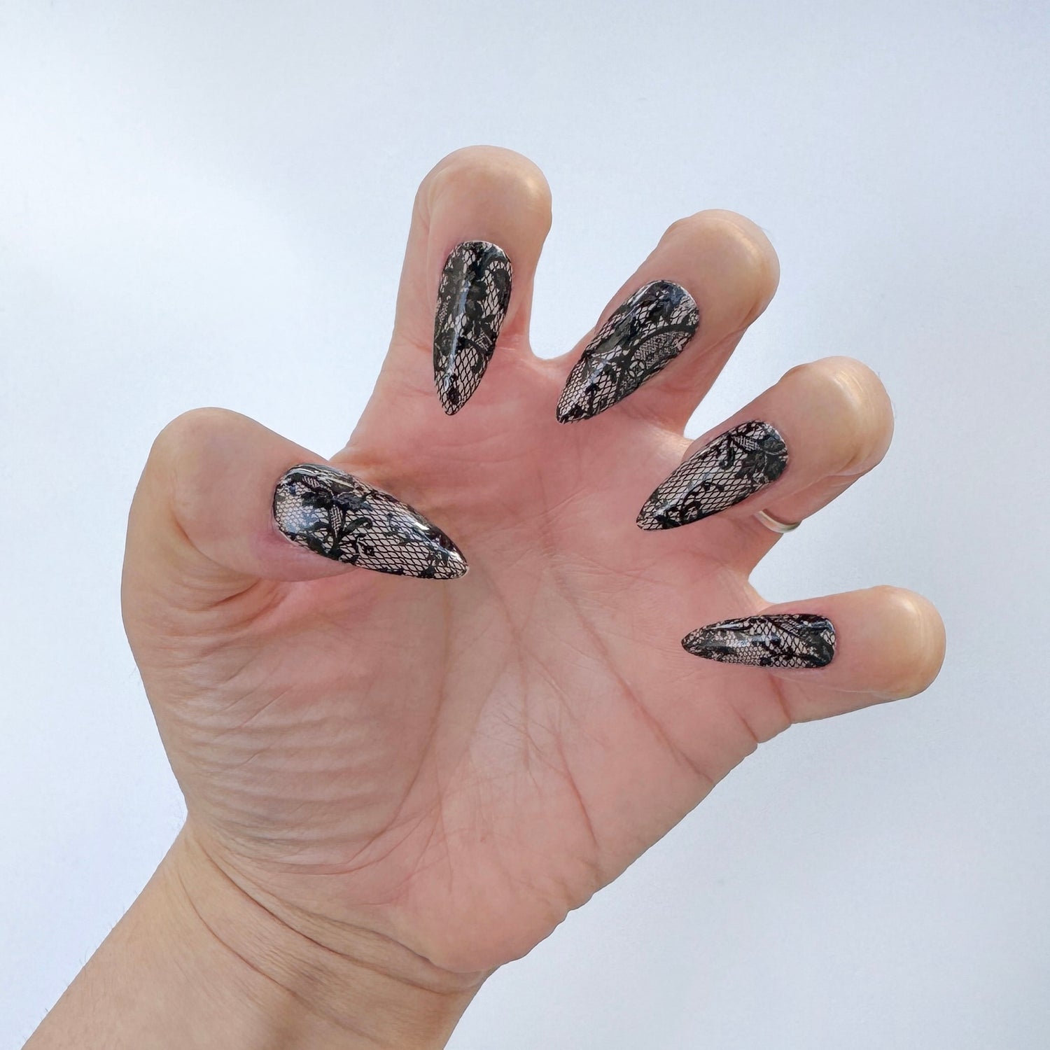 Get ready for "The Seductress" with these stunning, lace design press-on nails. Featuring a nude base and black lace design. Each set is a miniature work of art, meticulously designed and hand-painted, adding a unique flair to any occasion. No time for salon appointments? Say hello to instant glamour that’s ready whenever you are. Our durable, high-quality press-ons offer a flawless, comfortable fit and are designed to last.