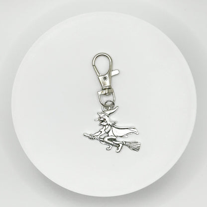 Soar into style with our magical flying witch charm! This unique, durable, and versatile accessory is perfect for witchy women and fantasy enthusiasts. Attach it to your bag, purse, or backpack for a touch of enchantment.