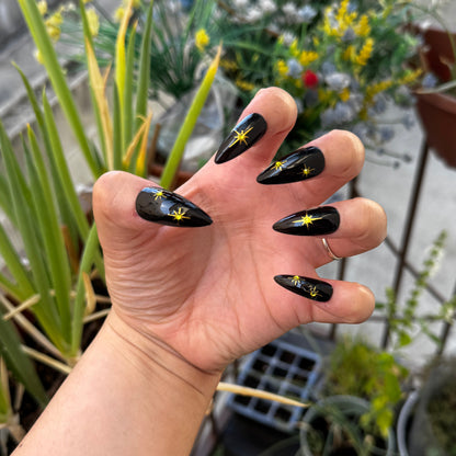 Get ready for "The Witching Hour" with these stunning, celestial press-on nails. Featuring a mysterious, deep black base and shimmering gold stars, this set captures the magic of a midnight sky. Each set is a miniature work of art, meticulously designed and hand-painted, adding a unique flair to any occasion. No time for salon appointments? Say hello to instant glamour that’s ready whenever you are. Our durable, high-quality press-ons offer a flawless, comfortable fit and are designed to last.